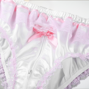 A close up of the zipper on the white satin panties, you can see the satin ribbon, lace and zipper.
