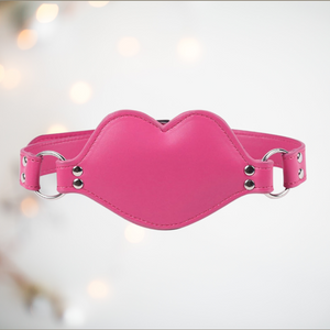 The pink PVC gag shown with the strap fixed in place.
