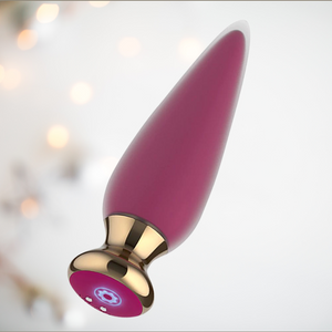 The Pink App Controlled Vibrator shown in full length, you can see the base where the charger attaches.