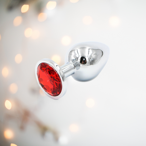 A side view of the red jewelled stainless steel butt plug.