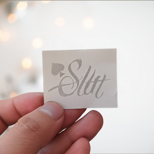 An image of the Slut temporary tattoo from House of Chastity before it is applied, please note that it will be back to front when you read it.