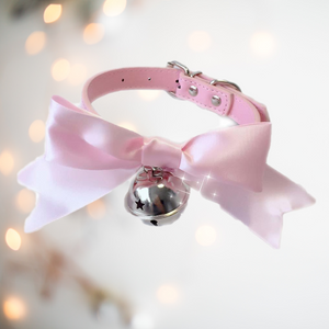 The pink soft ribbon collar bow from House Of Chastity, shown is the pink collar, matching soft satin ribbon and silver bell perfect attire for any sissy.