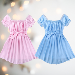 Shown here are both the pink and blue versions of the satin night dress. It is an above knee length dress with a skater skirt, ruched satin bodice, square neckline, ruched and lace edged short sleeves and matching satin tie belt that is tied into a large bow.