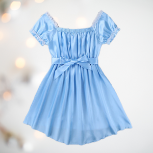 Shown here is the blue version of the satin night dress. It is an above knee length dress with a skater skirt, ruched satin bodice with decorative bow, square neckline, ruched and lace edged short sleeves and matching satin tie belt that has been tied at the front with a large bow.