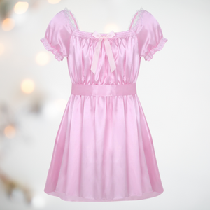 Shown here is the pink versions of the satin night dress. It is an above knee length dress with a skater skirt, ruched satin bodice with decorative bow, square neckline, ruched and lace edged short sleeves and matching satin tie belt that has been tied at the back.