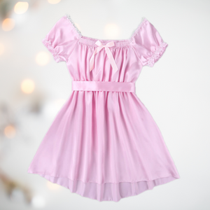 Shown here is the pink version of the satin night dress. It is an above knee length dress with a skater skirt, ruched satin bodice with decorative bow, square neckline, ruched and lace edged short sleeves and matching satin tie belt that has been tied at the back.
